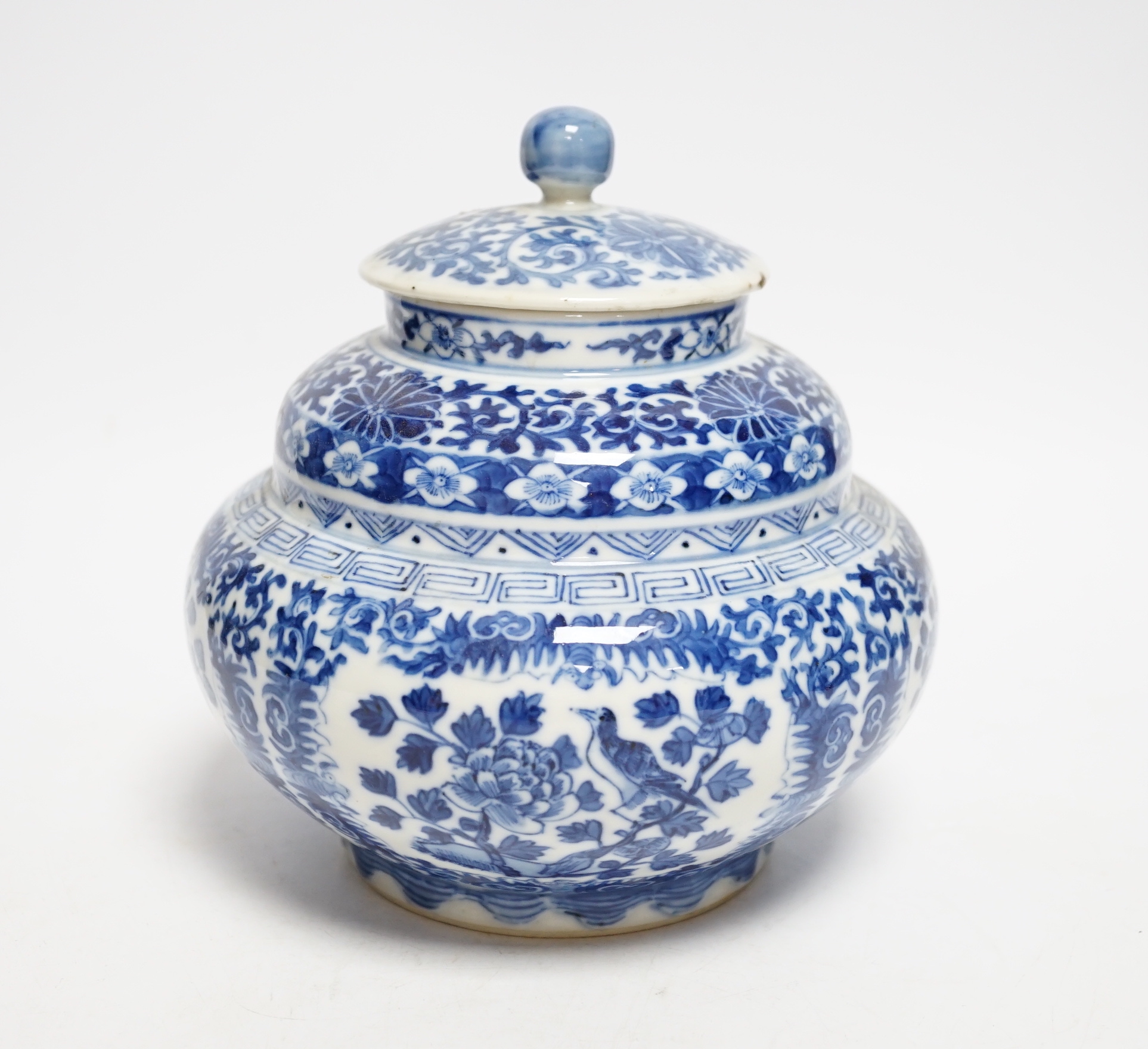 A late 19th century Chinese blue and white floral jar and cover, seal mark, 17cm high